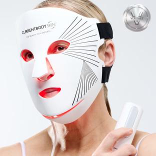Woman wearing LED light therapy face mask.