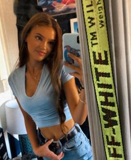 Mirror selfie of a young woman.