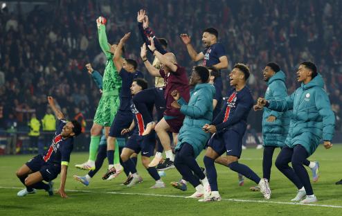 Paris St Germain players celebrating after a soccer match.