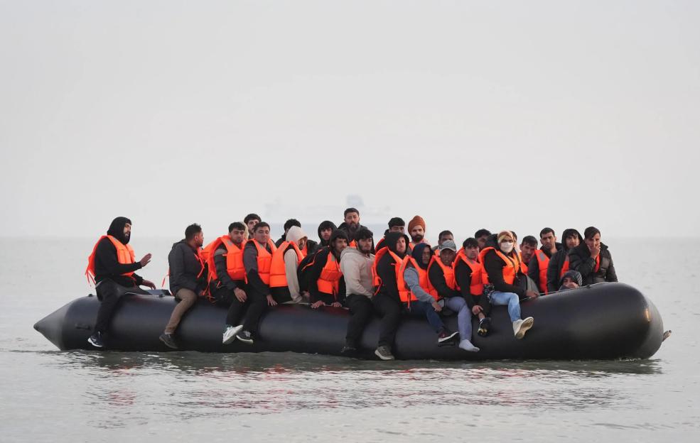 Migrants in a small boat crossing the English Channel.