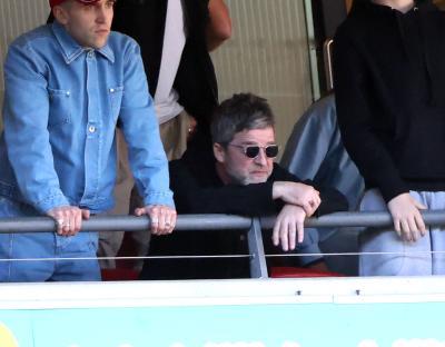 Noel Gallagher looking dejected at a soccer match.