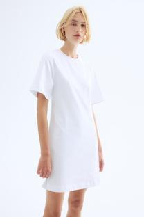 Woman in a white t-shirt dress.
