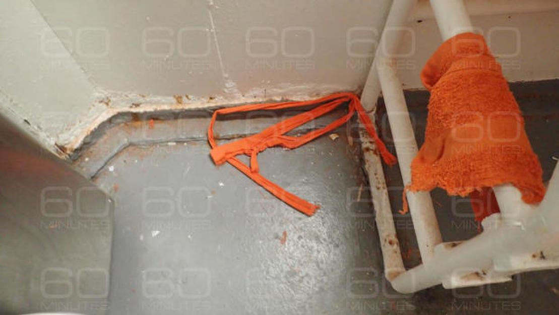 Image of the cell where Jeffrey Epstein killed himself, showing a torn orange fabric and orange towel tied to cell bars.