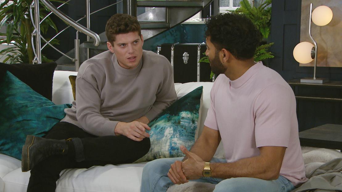Still image from Emmerdale: Suni and Nicky having a conversation on a couch.