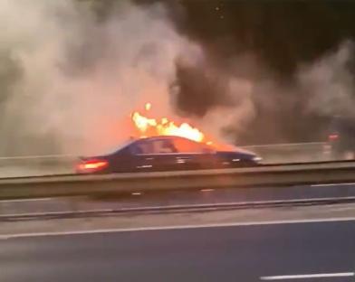 Car bursts into flames on M60 as plume of black smoke seen billowing into sky with traffic grinding to a halt
