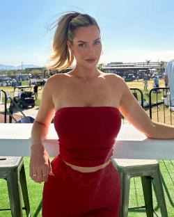 Paige Spiranac in a red tube top and pants.