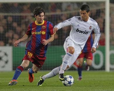Lionel Messi and Cristiano Ronaldo vying for the ball during a soccer match.