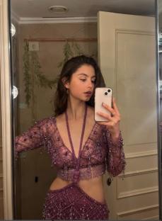 Carys Douglas, daughter of Michael Douglas and Catherine Zeta-Jones, taking a selfie in a purple beaded outfit.
