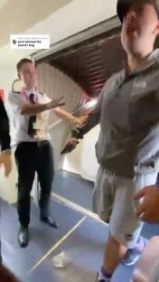 A passenger being restrained by airport staff.