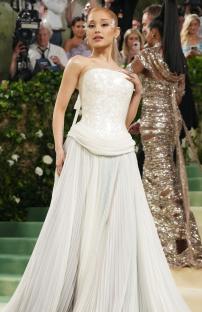 Ariana Grande at the Met Gala in a white pleated gown.