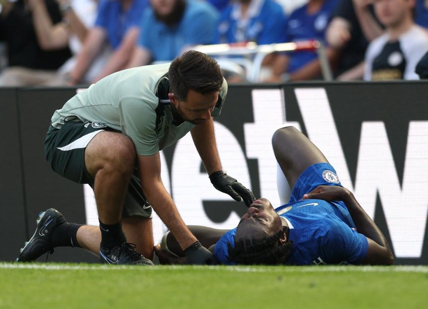 Chelsea's Trevoh Chalobah receiving medical attention on the field.
