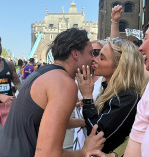 Couple kissing after a marathon.