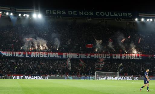Paris Saint-Germain fans holding a banner that reads