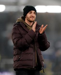 Tom Lockyer clapping at a soccer match.