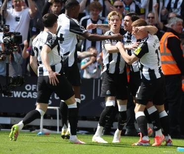 Newcastle United players celebrating a goal.