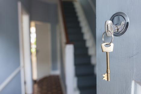House key in front door lock.