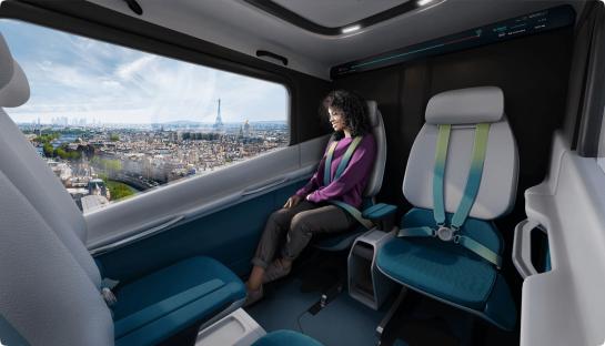 a woman sits in a car with a view of paris
