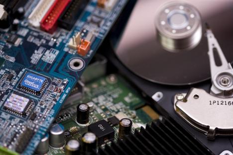Close-up of computer circuit boards and hard drive components.