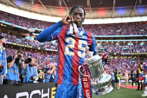 Romain Esse of Crystal Palace holding the FA Cup trophy.