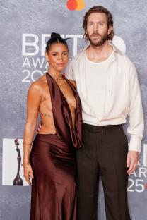 Vick Hope and Calvin Harris at an awards ceremony.