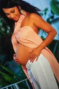 Pregnant woman holding her belly.