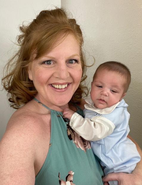 A woman holding her newborn baby.