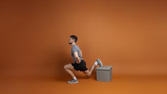 Man performing a leg exercise using a box.