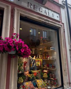 Shop window display with colorful pillows and ceramics.