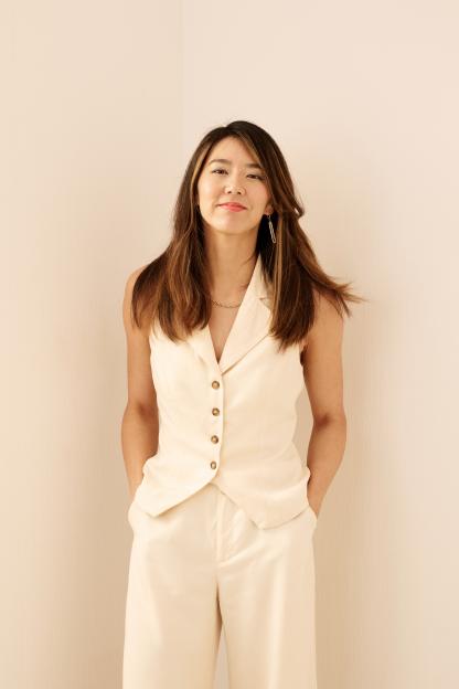 Portrait of Elizabeth Lo in a cream-colored pantsuit.