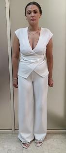 Charlotte May Lee in a white pantsuit.