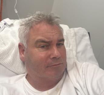 Eamonn Holmes in a hospital bed.