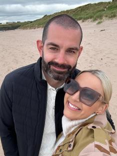 Couple smiling at the beach.