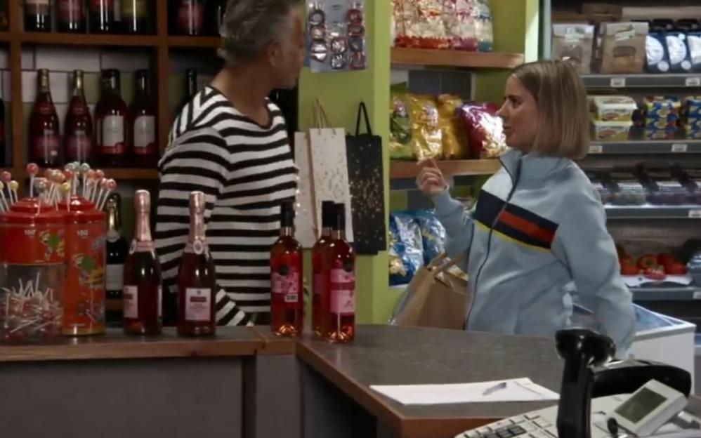Screenshot of two people conversing in a store.