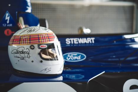 Signed racing helmet on a blue race car.