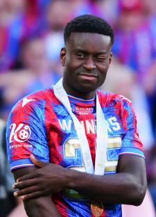 Marc Guéhi of Crystal Palace with an eye injury, wearing a winner's medal.