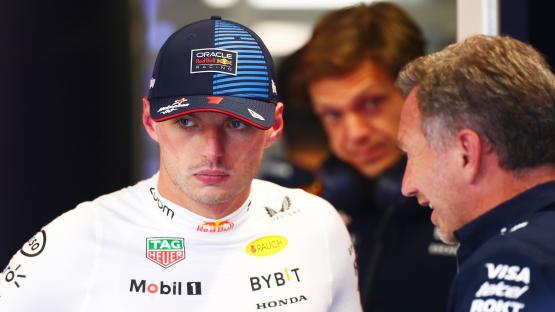 Max Verstappen of Red Bull Racing speaking with a team member.
