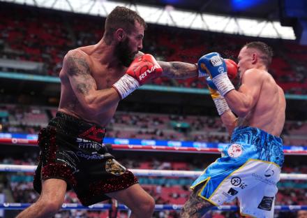 Anthony Cacace and Josh Warrington boxing at Wembley Stadium.