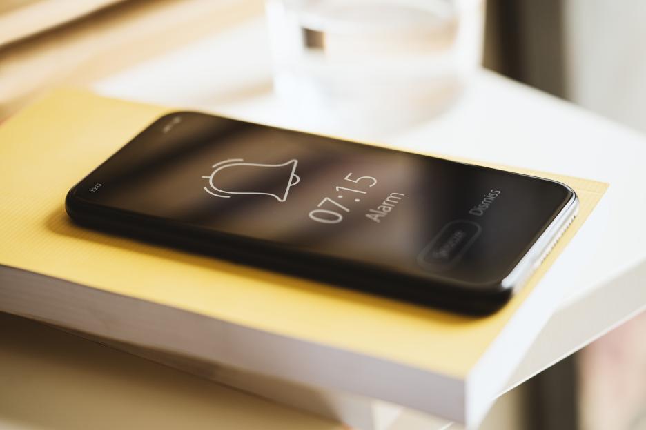 Smartphone alarm ringing at 7:15 AM.