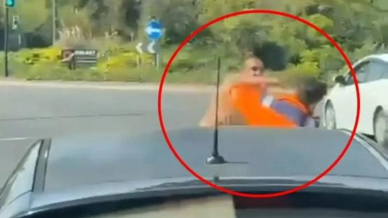 Shocking moment ‘road rage’ motorist swings PUNCHES at recovery truck driver in blazing row at roundabout