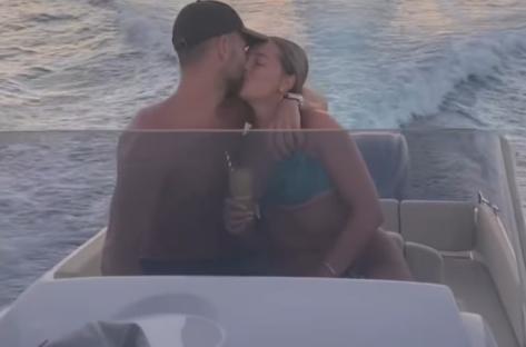 Couple kissing on a boat.