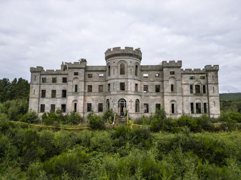 Ruined Dalquharran Castle overgrown with vegetation.