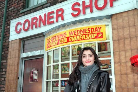 Rebecca Sarker as Nita Desai in Coronation Street, standing outside a corner shop.