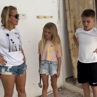 Woman and two children at a construction site.