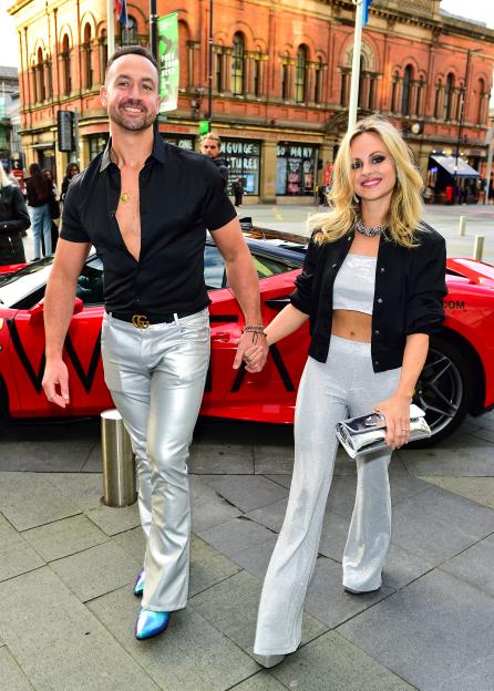Adam Crofts and Tina O'Brien holding hands.