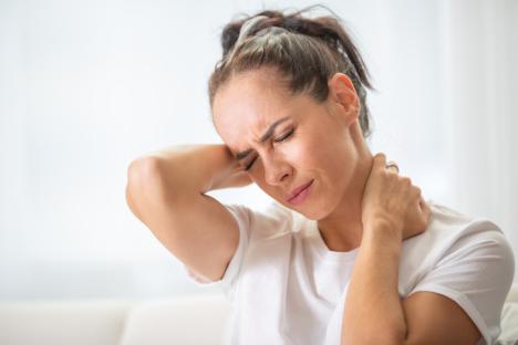 Woman holding her neck in pain.