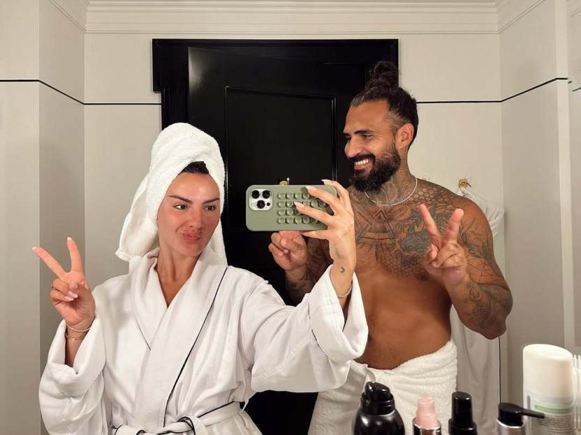 Couple taking a selfie in a bathroom.