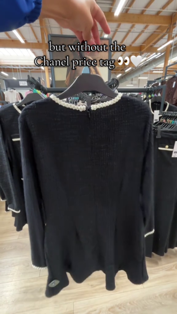 Black dress on a hanger, similar in style to Chanel but at a lower price.