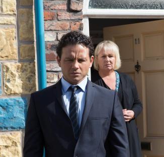 Photo of Coronation Street actors Ryan Thomas and Sue Cleaver at a funeral.