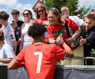 Cristiano Ronaldo Jr. with his grandmother after a soccer match.