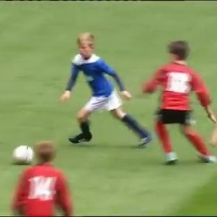 Video still of a young boy playing soccer at Wembley Stadium.